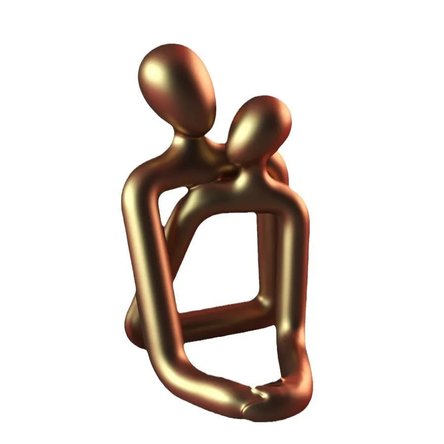Modern minimalist loving couple resin statue in Gold or Milky White finish on a wooden surface.