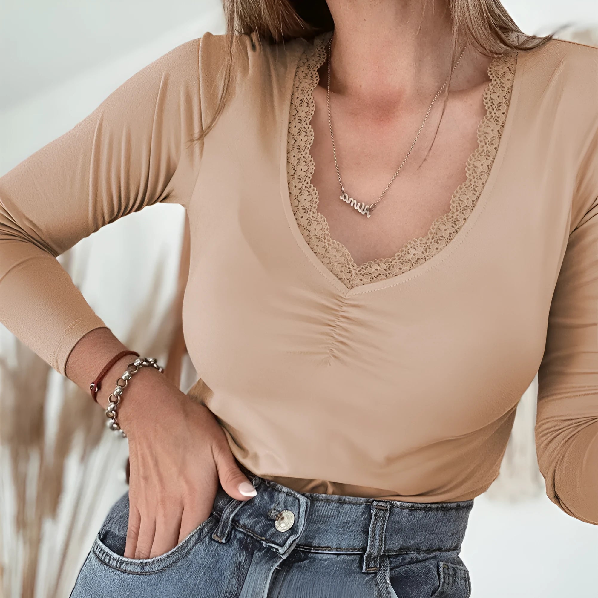 Women's red slim fit long sleeve casual top with delicate lace trim detail on the sleeves.