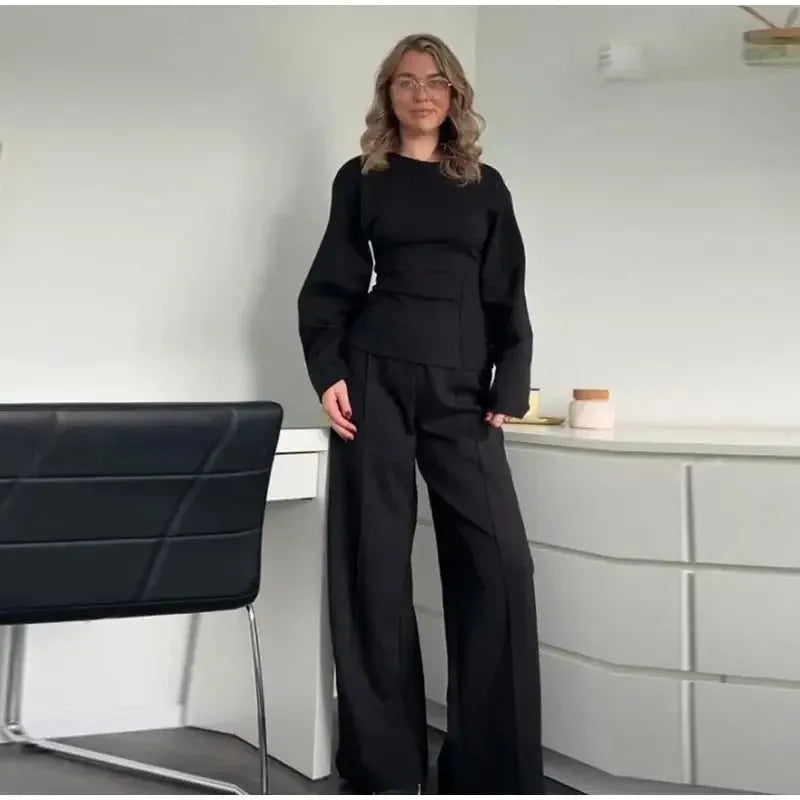Women's apricot colour polar fleece lounge suit featuring a long sleeve pleated top and wide-leg trousers.