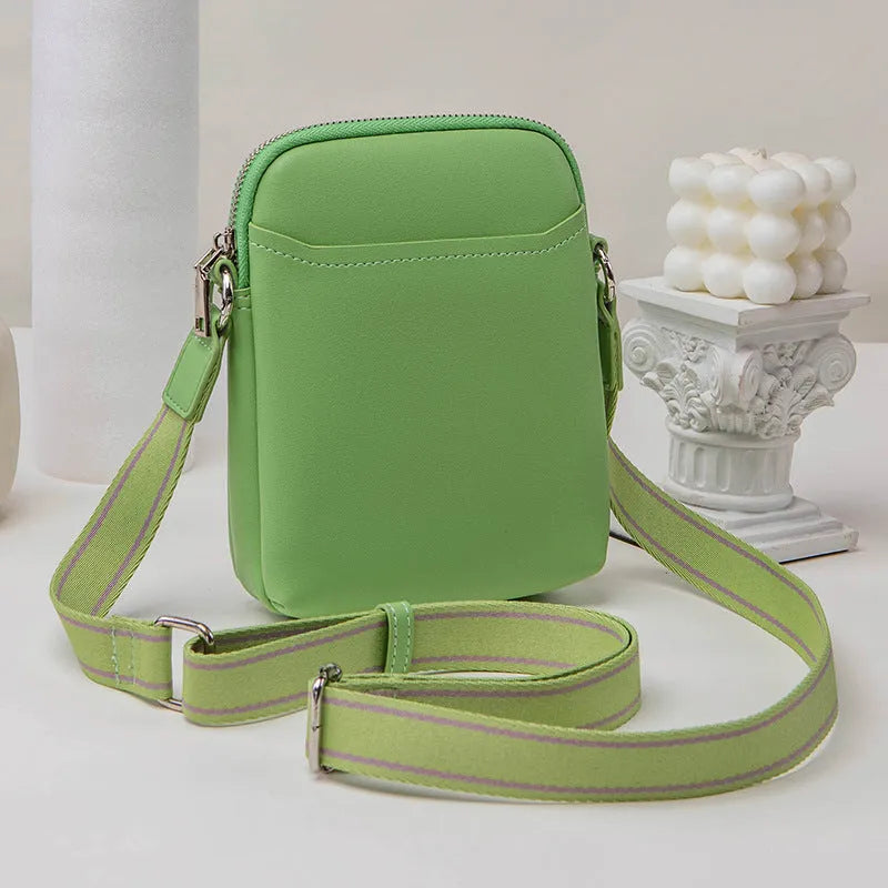 Solid colour small crossbody mobile phone bag in beige, showing front view and adjustable strap.