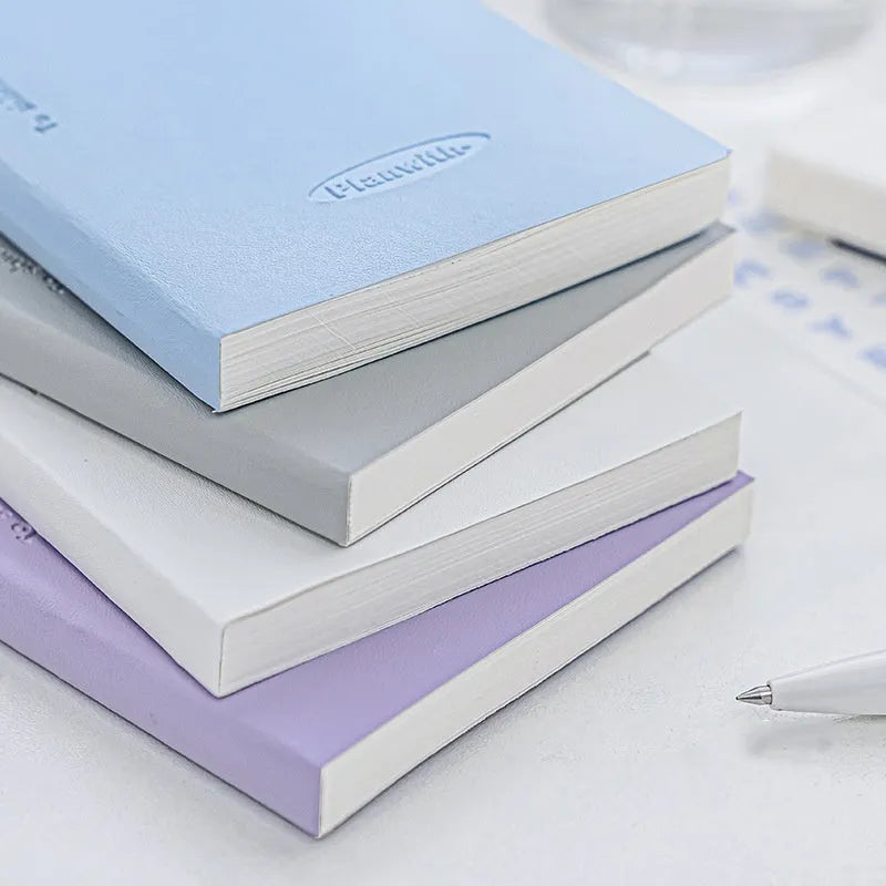 Embossed meter book notebook open showing white 100g paper, with blue, grey, purple, and white cover options.