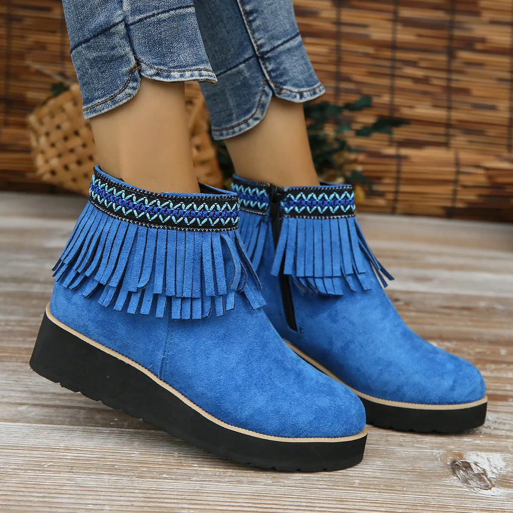Women's black suede wedge ankle boots with side zip, tassel, and thick rubber sole.