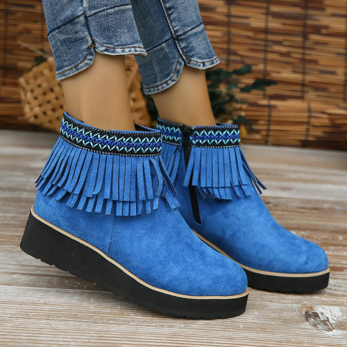 Women's black suede wedge ankle boots with side zip, tassel, and thick rubber sole.