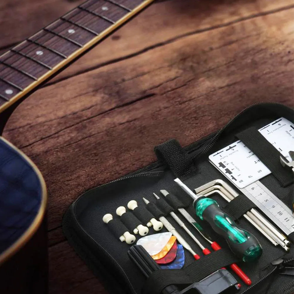Black guitar repair tool kit open to show metal and plastic maintenance tools for guitars and other string instruments.