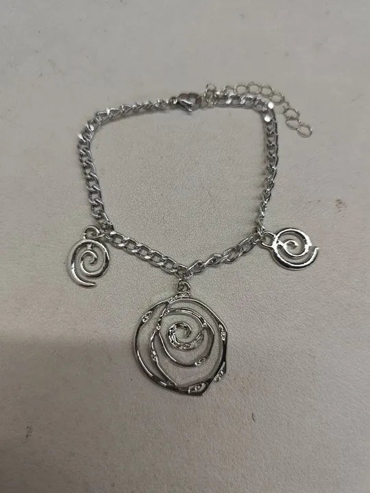 Women's spiral donut jewellery set showing matching necklace, bracelet and ear hooks in gold or silver electroplated alloy