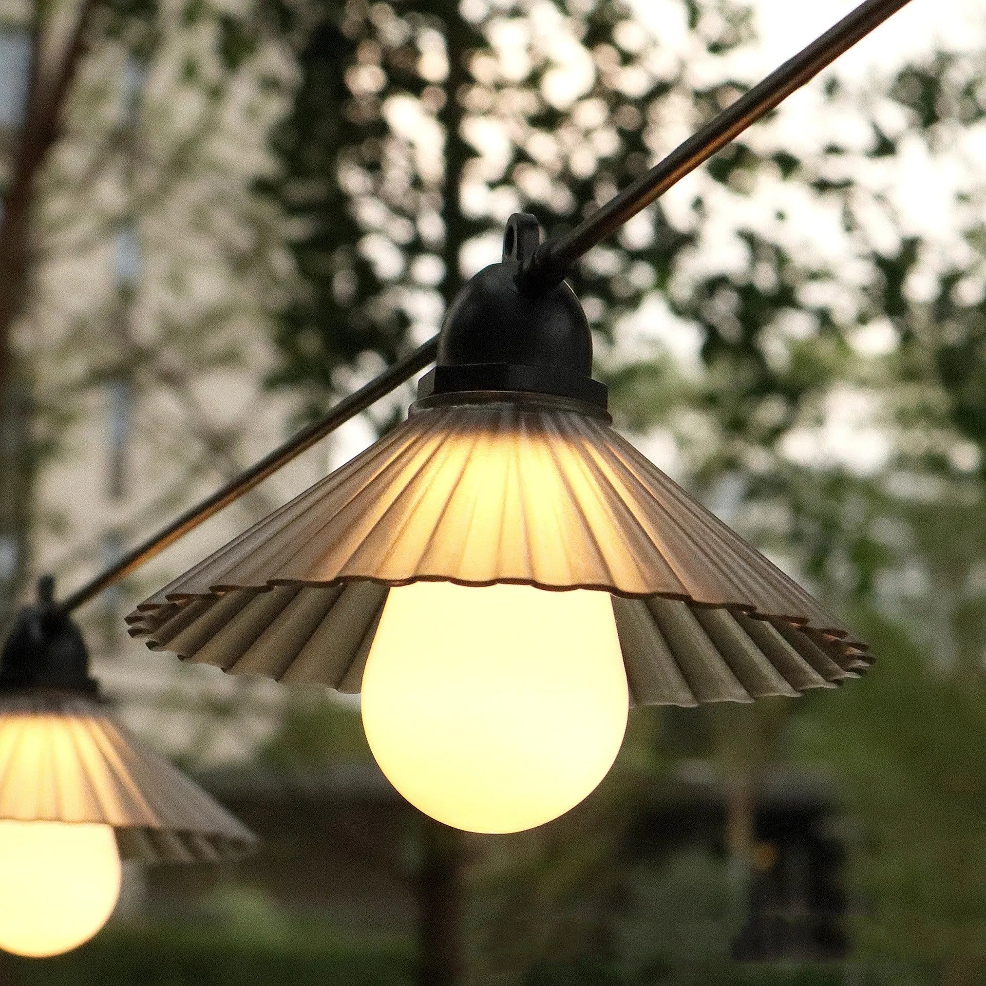 Outdoor LED string lights with flower-shaped bulbs in warm white and coloured options for garden and camping