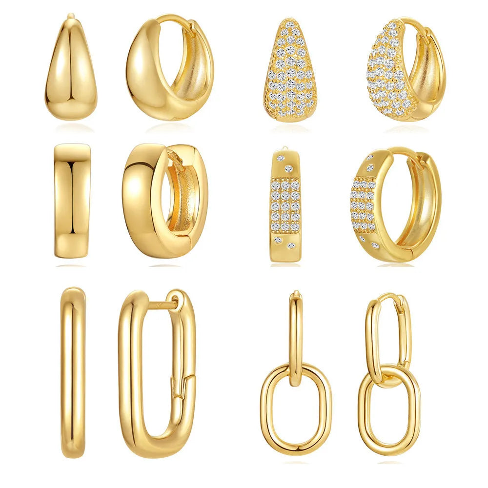 A pair of simple geometric brass earclip earrings with a round element and electroplated golden finish.