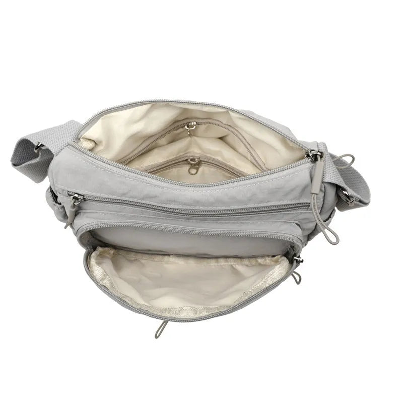 Trendy water-repellent nylon crossbody cloth bag in black with single shoulder strap and outer pocket