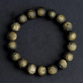 Natural obsidian crater ball bracelet with polished beads in silver or gold meteorite finish.