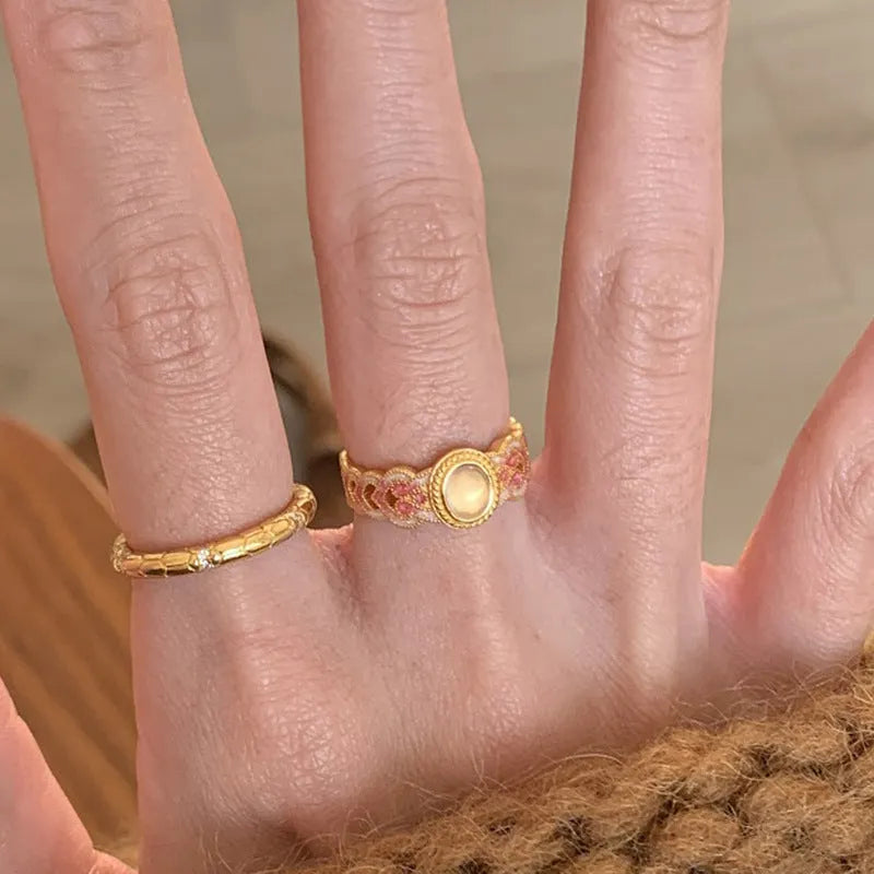 Women's geometric open ring with pink crystal enamel detail on gold-plated copper.