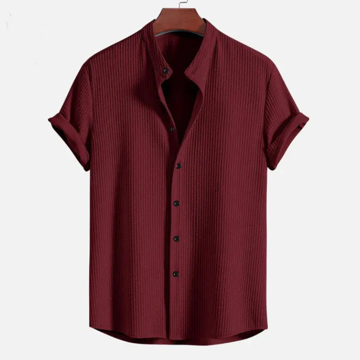 Men's loose fit short sleeve polyester summer shirt on a hanger, shown in a light blue colour.