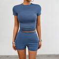 Solid colour women's sportswear set featuring a slim fit t-shirt and elasticated shorts.