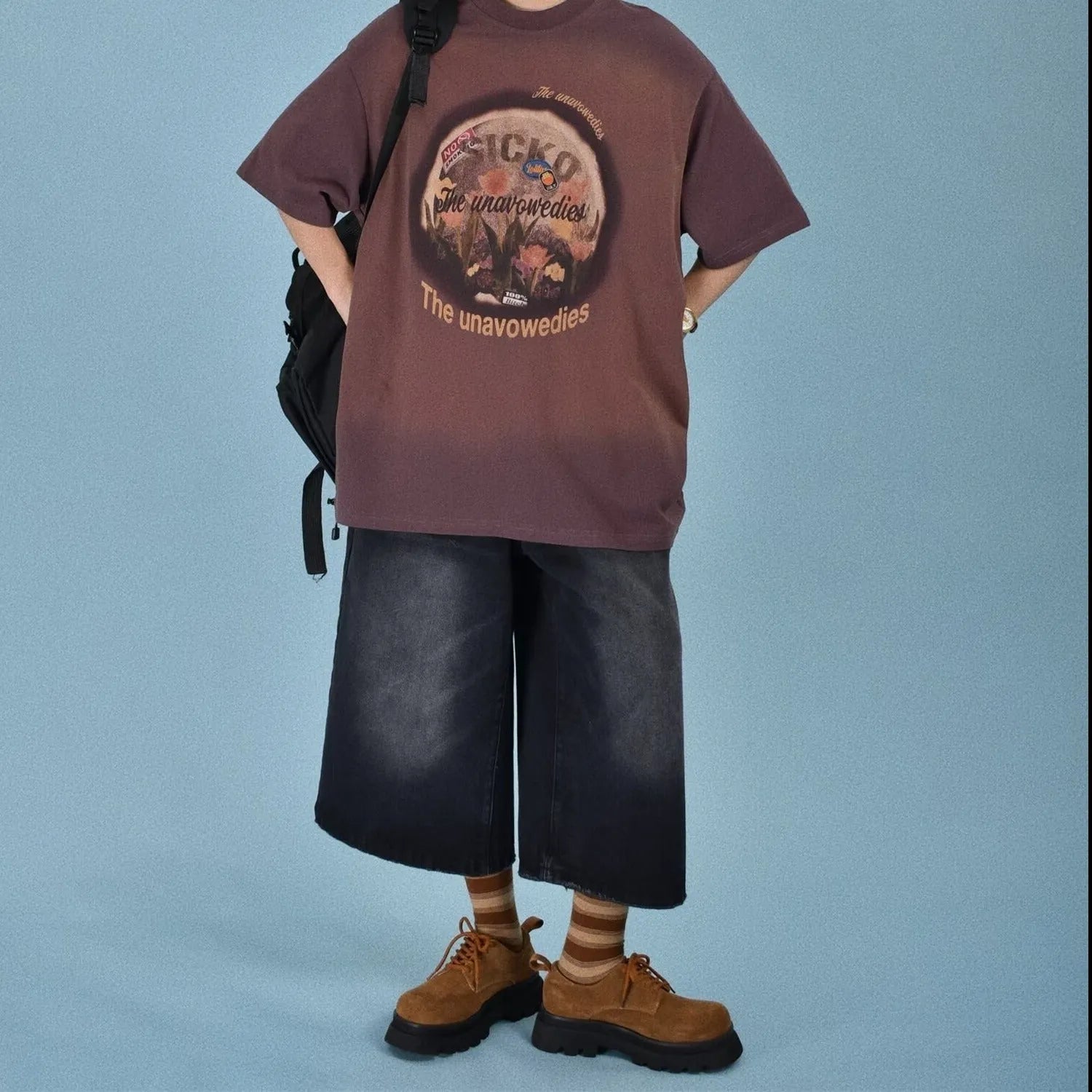 Man wearing blue loose straight-leg denim shorts for summer.