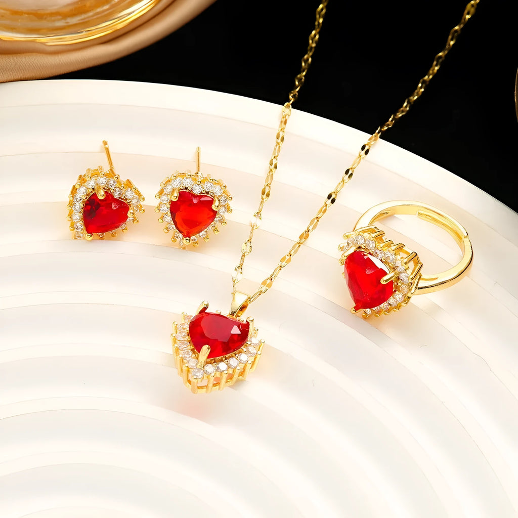 Gold red titanium steel jewellery set with heart flower pendant, matching earrings, and ring on a water wave chain.