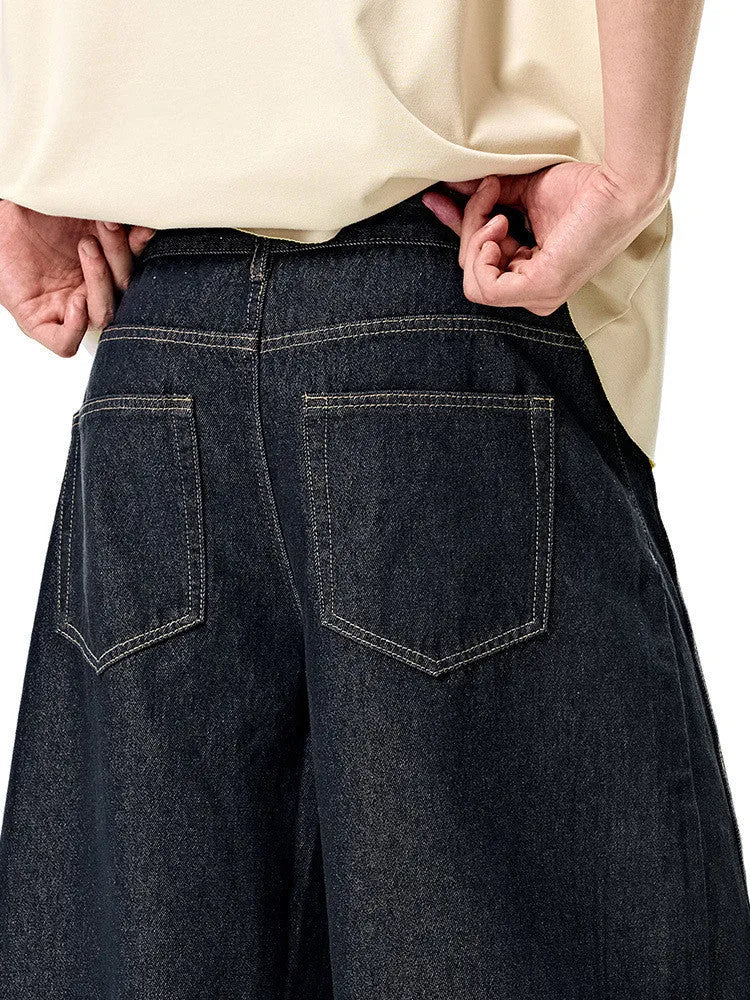 Men's original cow coloured wide leg denim trousers with a mid waist, laid flat.