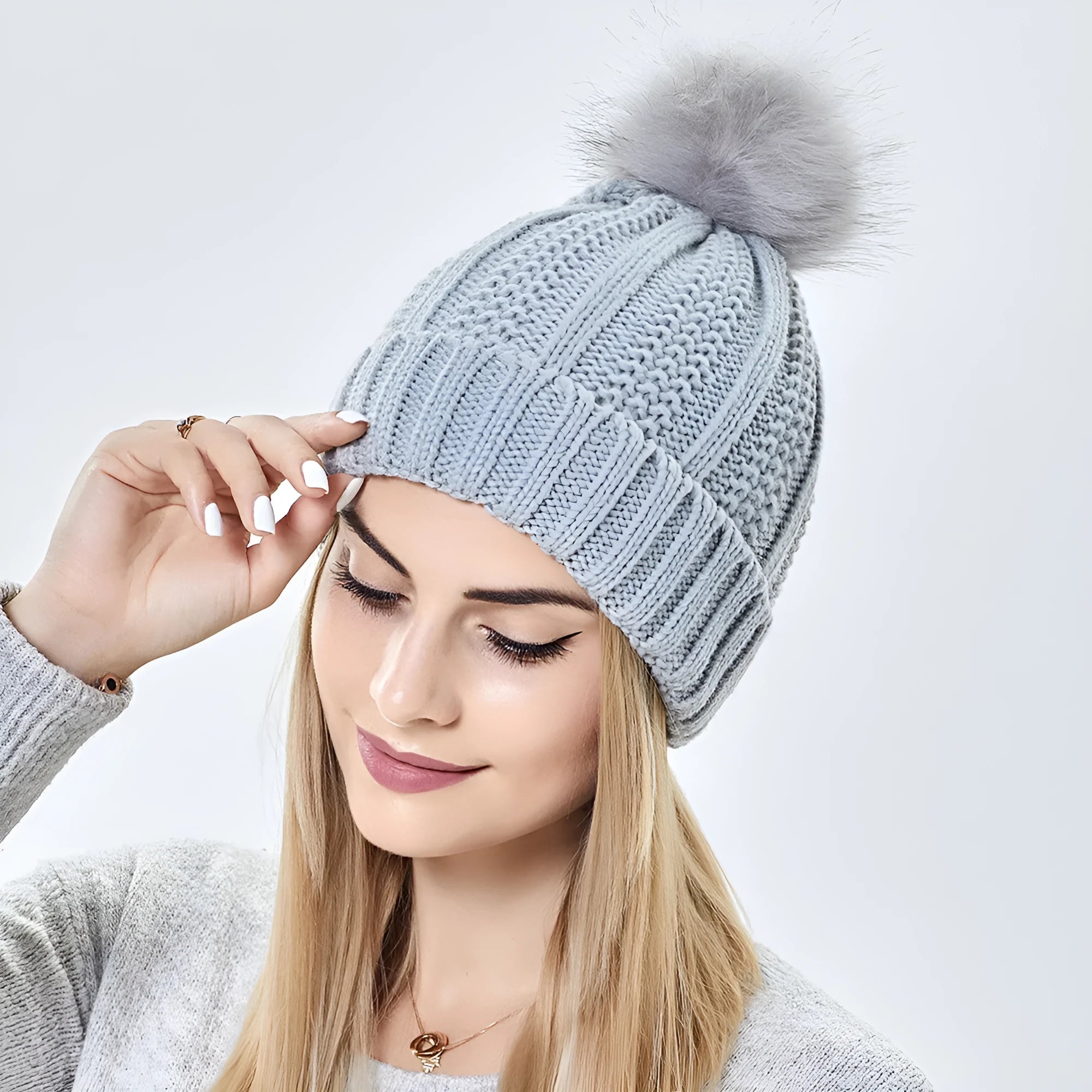 Wool knit beanie hat for women with faux fur pom pom and satin lining in beige colour