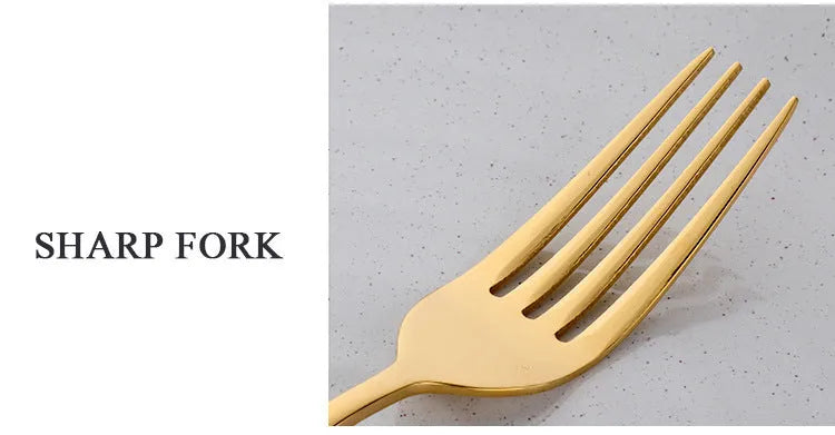 Four-piece stainless steel cutlery set with mirror-polished black finish laid out on a surface