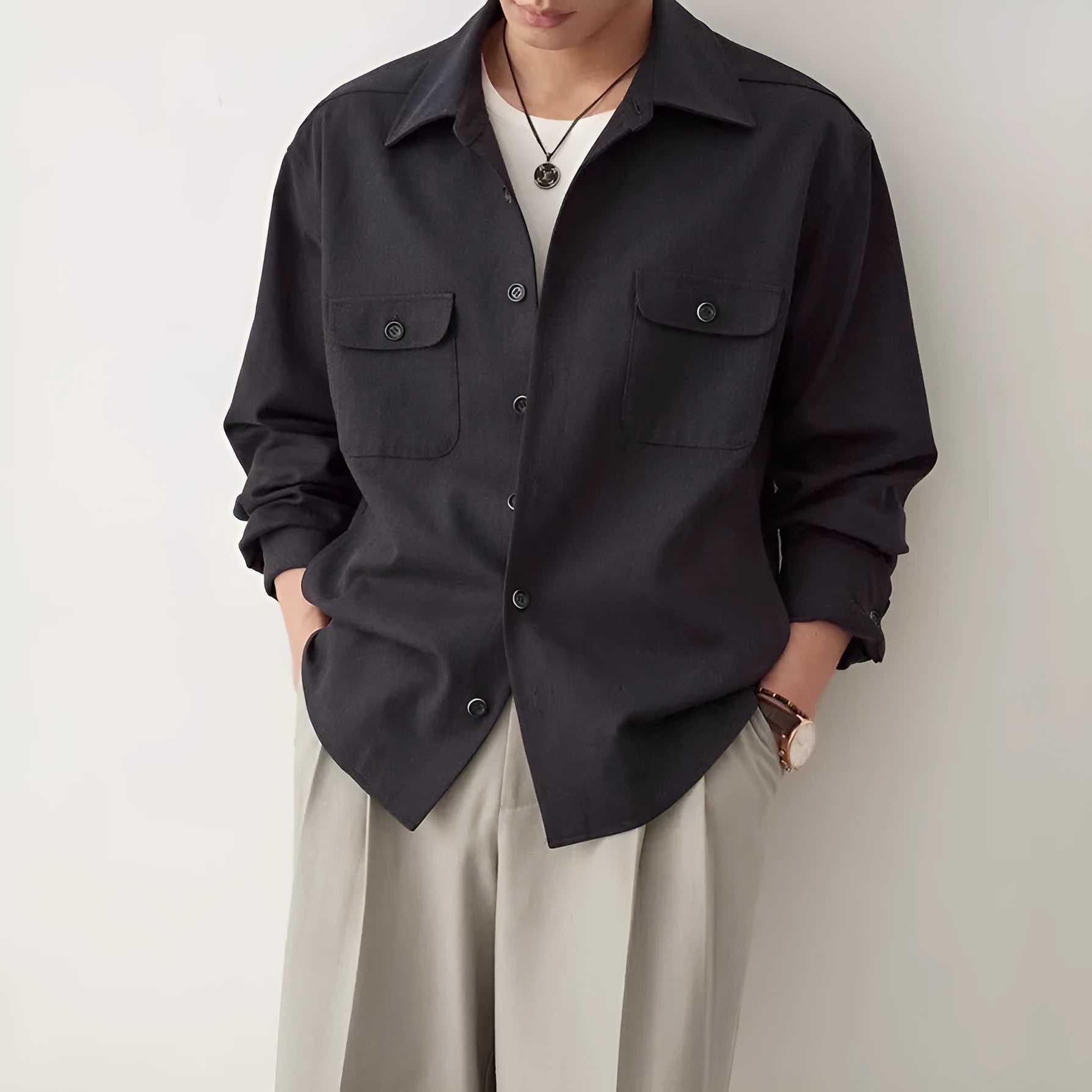 Men's light sand rice coloured long sleeve shirt with a lapel collar, laid flat to show front design.