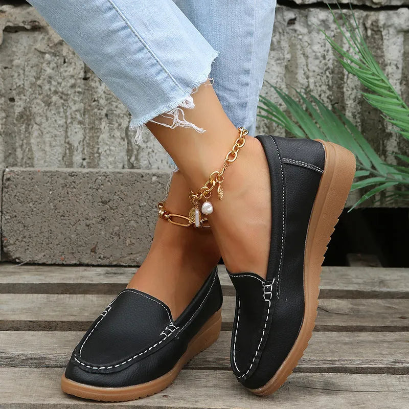 Women's flat slip-on loafers in PU leather, showing round toe and available colour options