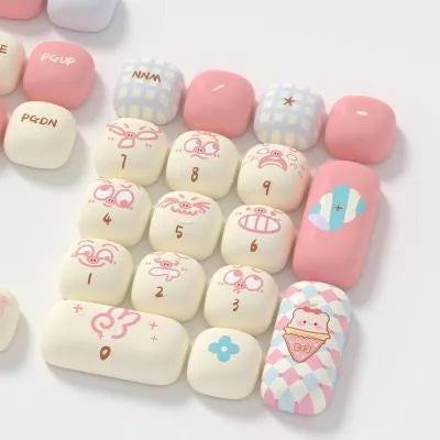 Sublimation printed mechanical keyboard keycap sets showing cartoon pig, capybara, and candy designs.