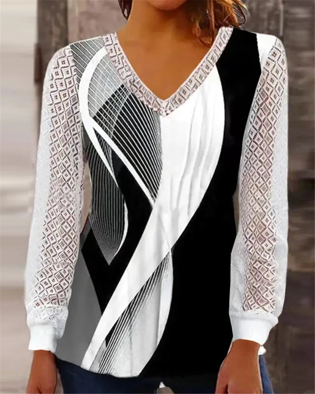 Purple loose V-neck women's top with a white hollow-out lace print pattern and long sleeves.