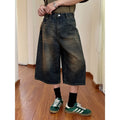 Man wearing blue loose straight-leg denim shorts for summer.