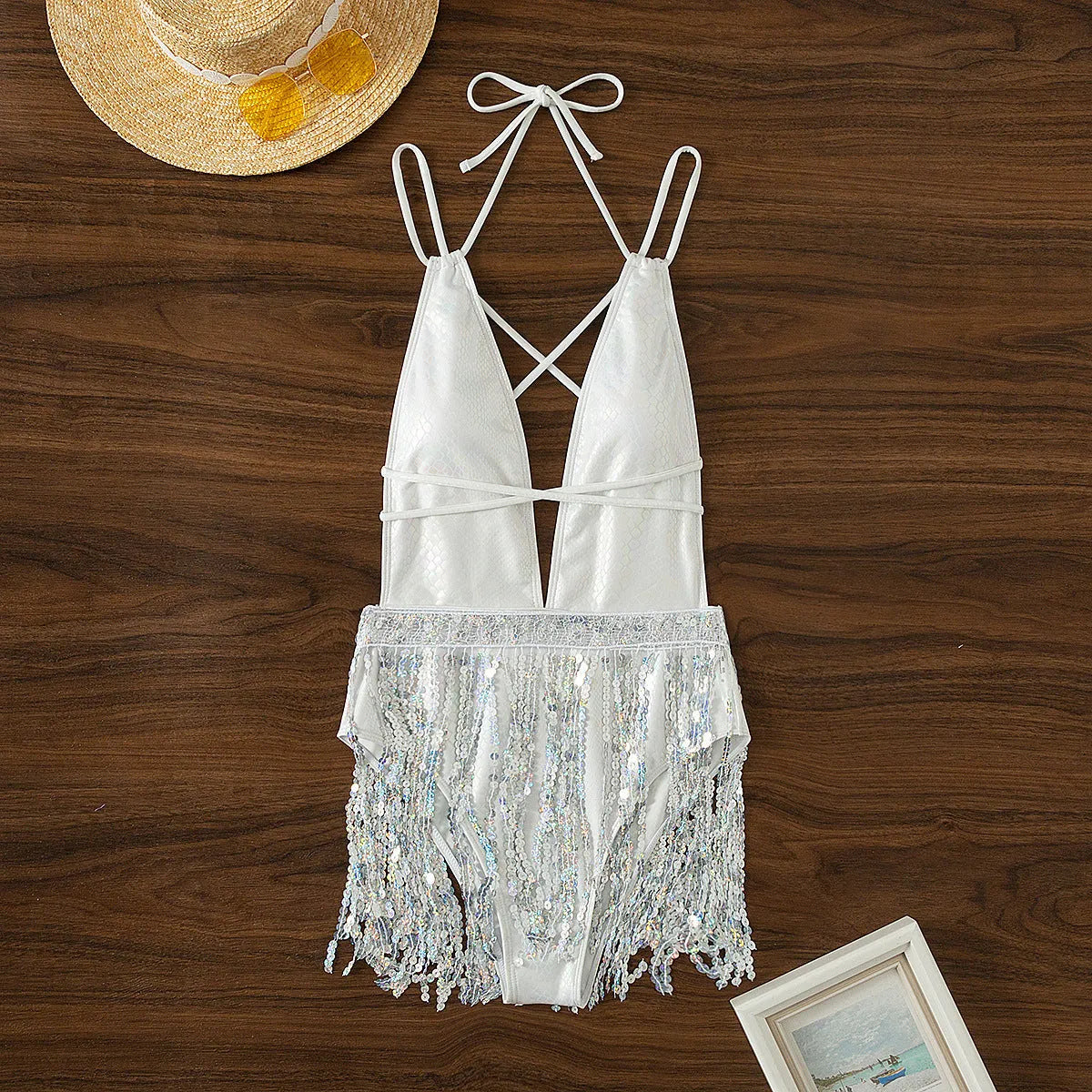White women's one-piece swimsuit with deep V-neck and tassel detailing
