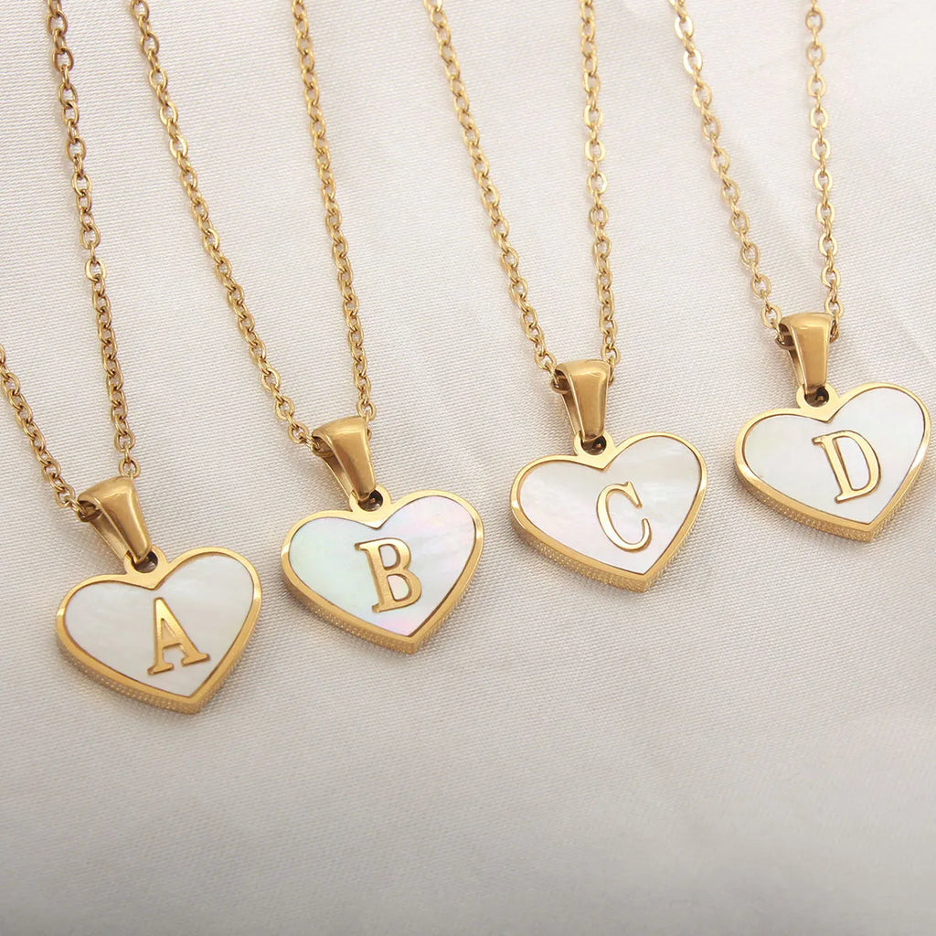 Gold plated heart-shaped personalised necklace with white shell charm on an adjustable chain.