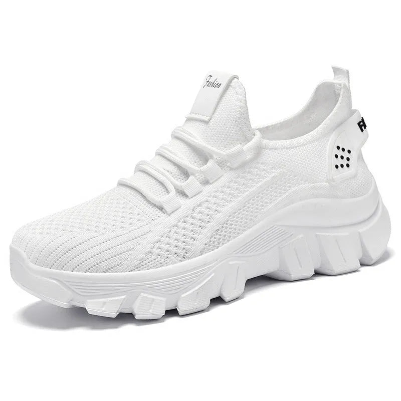 Women's white Flyknit sneaker with thick sole and lace-up front, shown on a neutral background