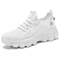 Women's white Flyknit sneaker with thick sole and lace-up front, shown on a neutral background