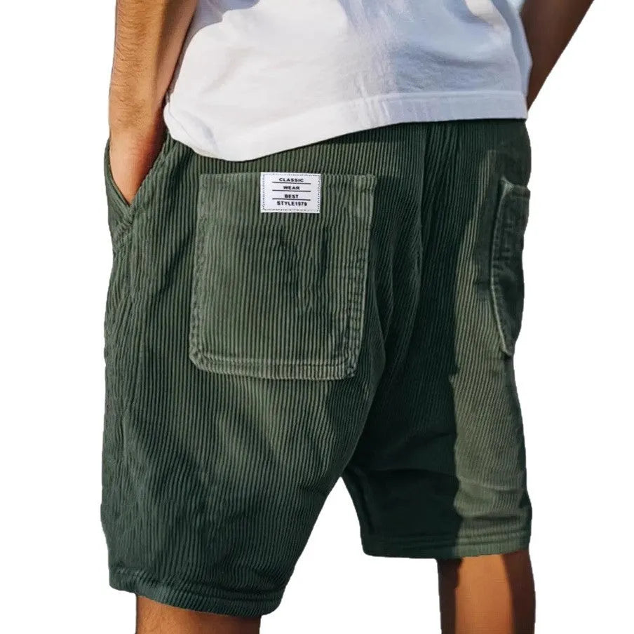 Men's grey corduroy shorts with multiple pockets and embroidery detail on leg, laid flat.