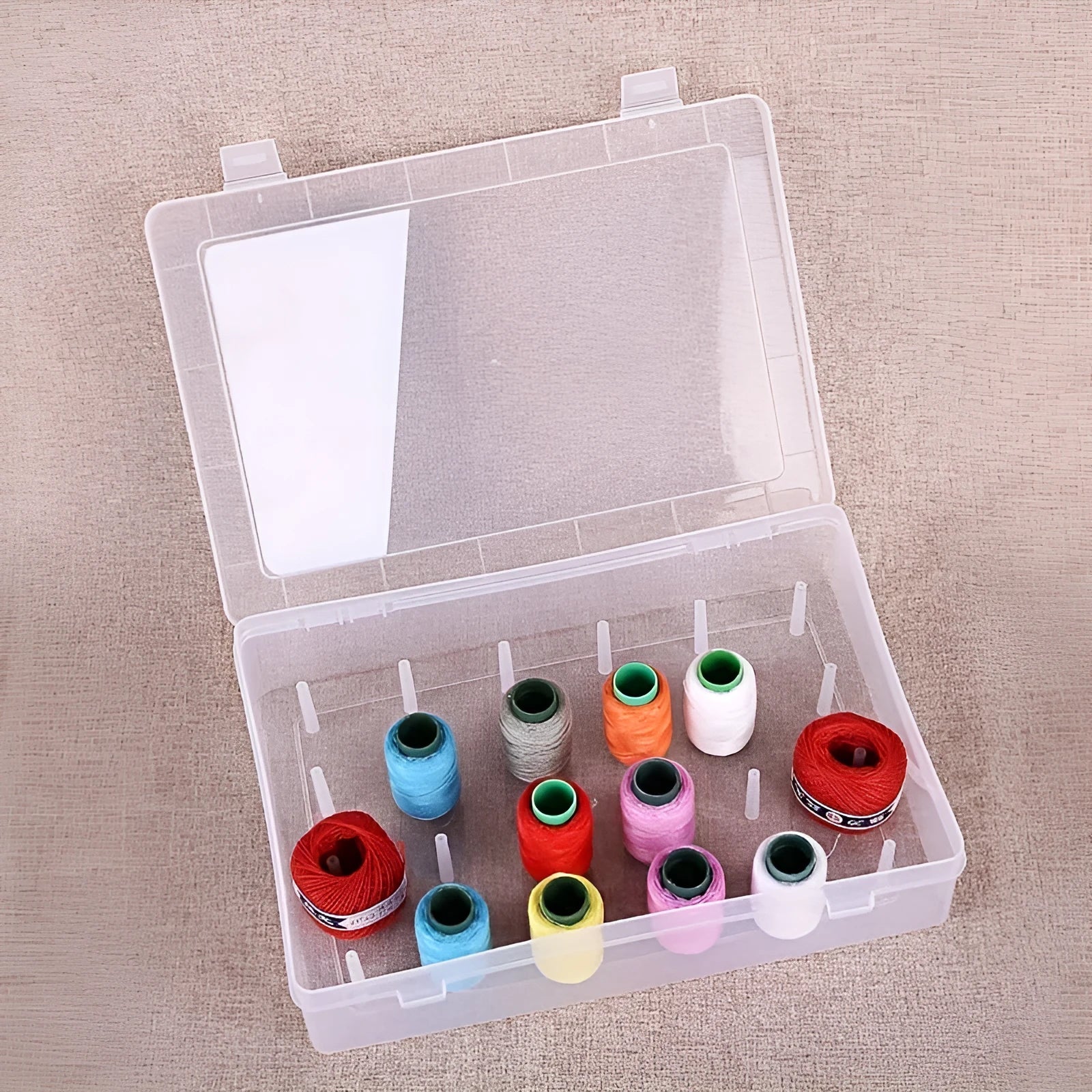 42-compartment plastic storage box for embroidery supplies in transparent, pink, or blue colour options.