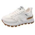 White and black unisex low-top sneakers with round toe and front lace-up on rubber sole