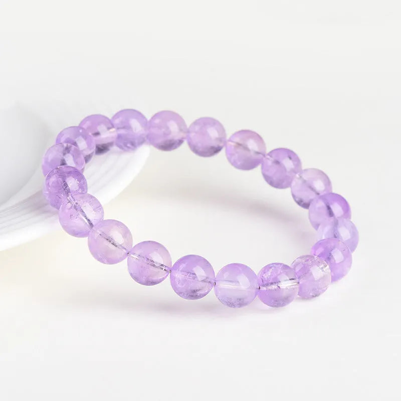 Lavender amethyst bracelet with round beads in a water ripple pattern, showing cream body and transparent colour options.