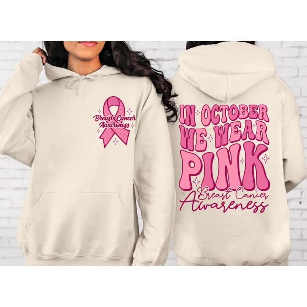 Pink pullover hoodie with a breast cancer awareness slogan, retro graphic, and side seam pockets.
