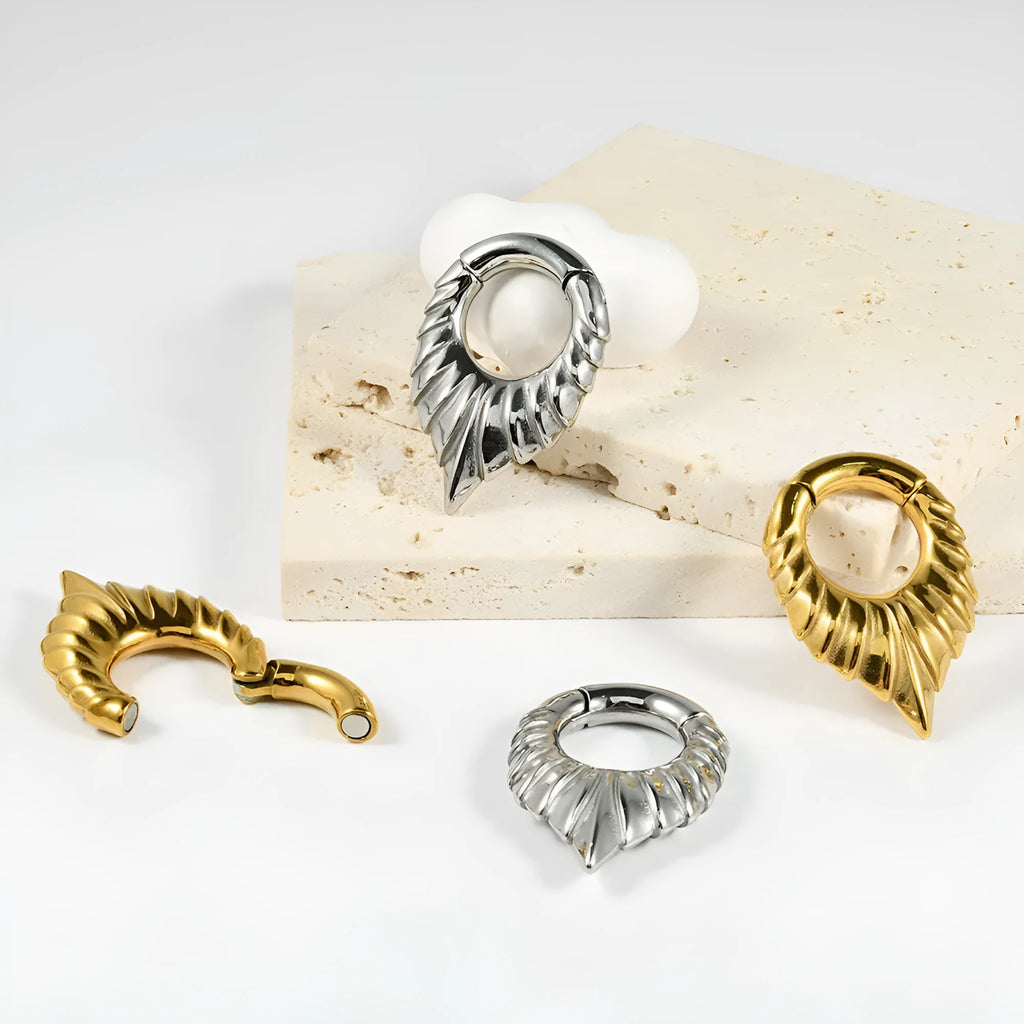 Stainless steel drop-shaped auricle ear extender with round hanging egg design in totem style.