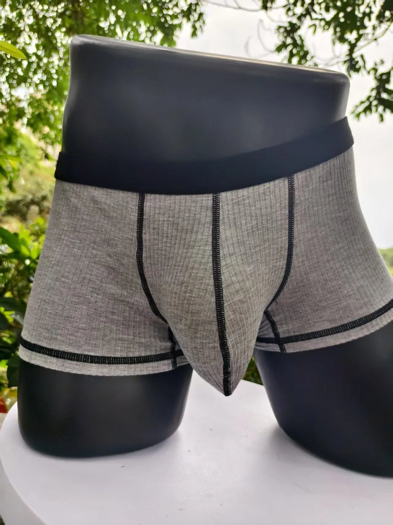 Men's breathable boxers in Army Green solid colour showing thin fabric construction and body shaping design