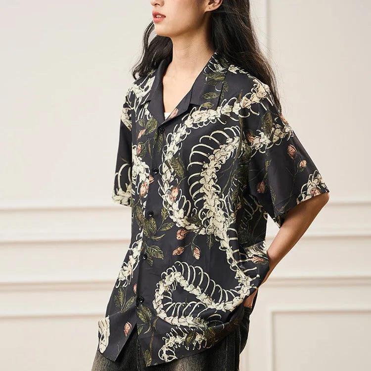 Short sleeve loose fit shirt with snake bone and floral pattern print and a Cuban collar.