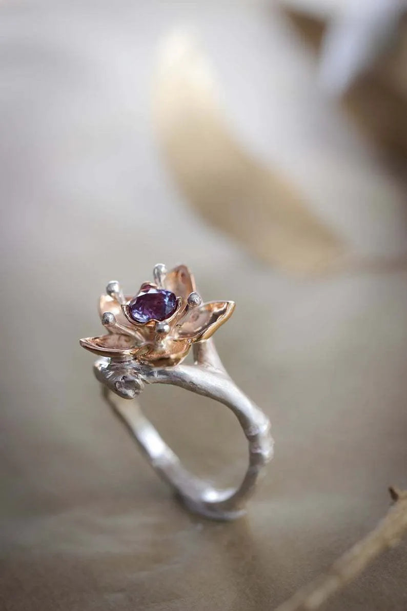 Silver two-tone women's ring with geometric shapes and floral design elements on alloy metal