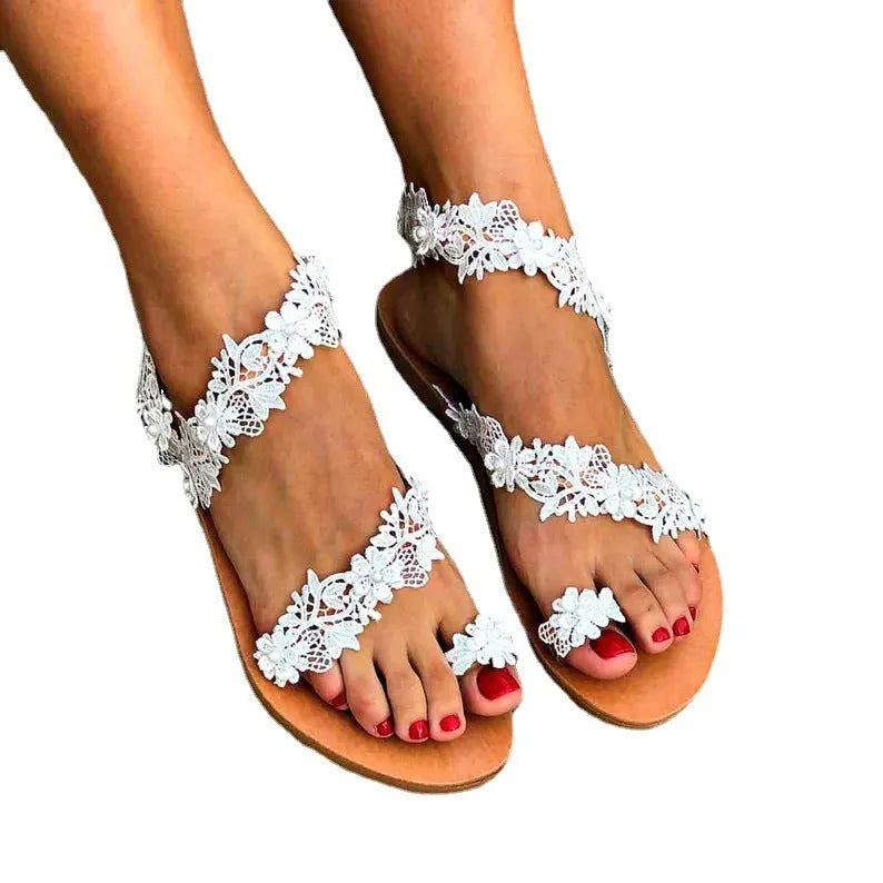 White plus size women's flat sandals with rhinestone flower decoration and round toe.