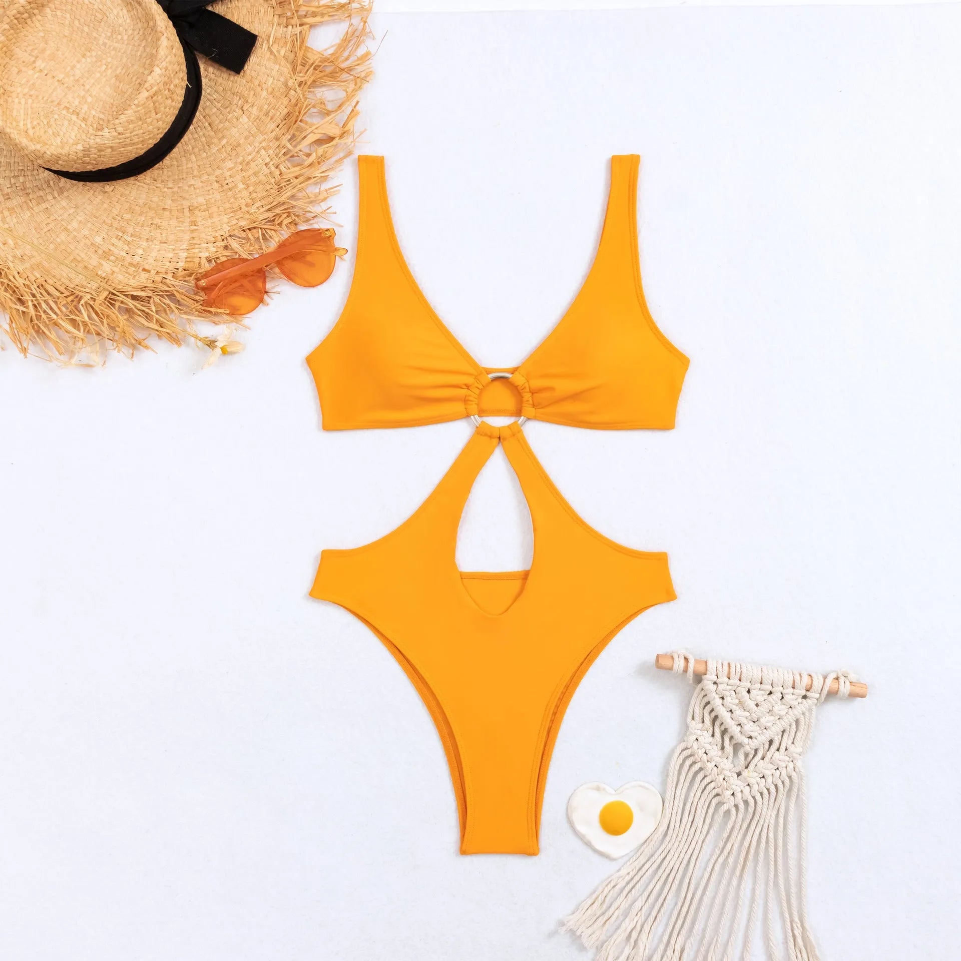 Women's black triangle one-piece swimsuit on a hanger, sleeveless design, made from nylon fabric.