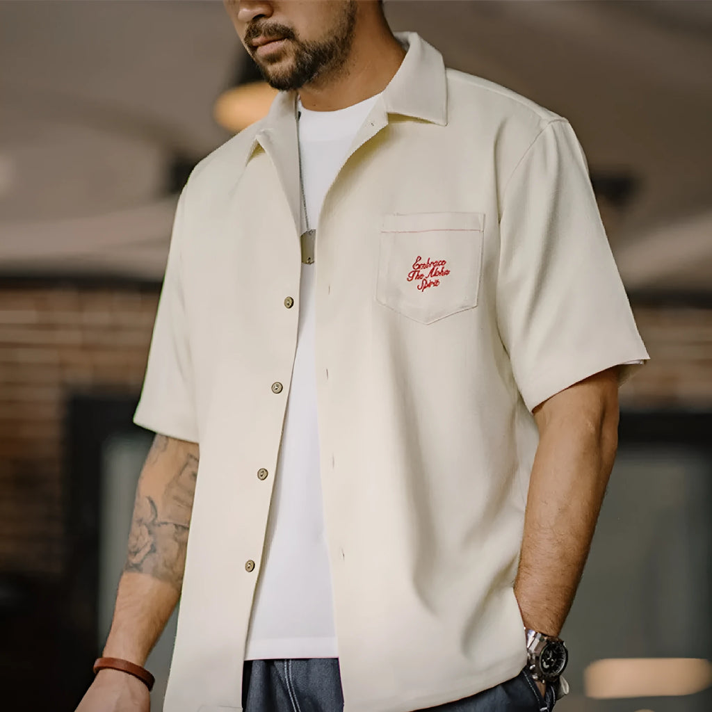 Light apricot men's shirt with a bamboo and floral pattern and a Cuban collar.