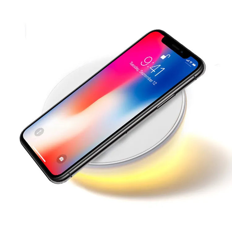 White wireless phone charger with digital clock display, three control buttons, and LED night light