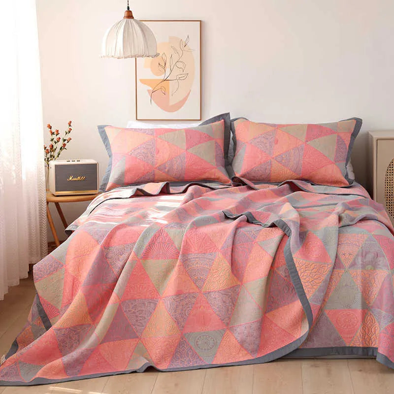 Three-piece cotton gauze bed blanket set with floral botanical pattern, shown with pillowcases.