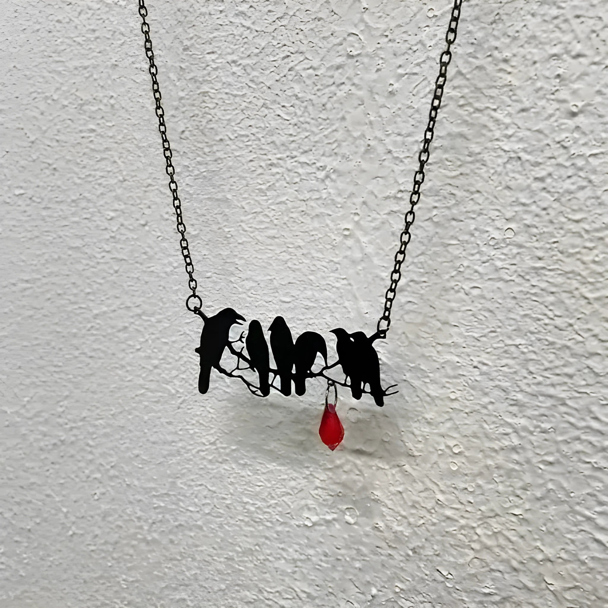 Black crow necklace on cross chain with electroplated finish and animal modelling