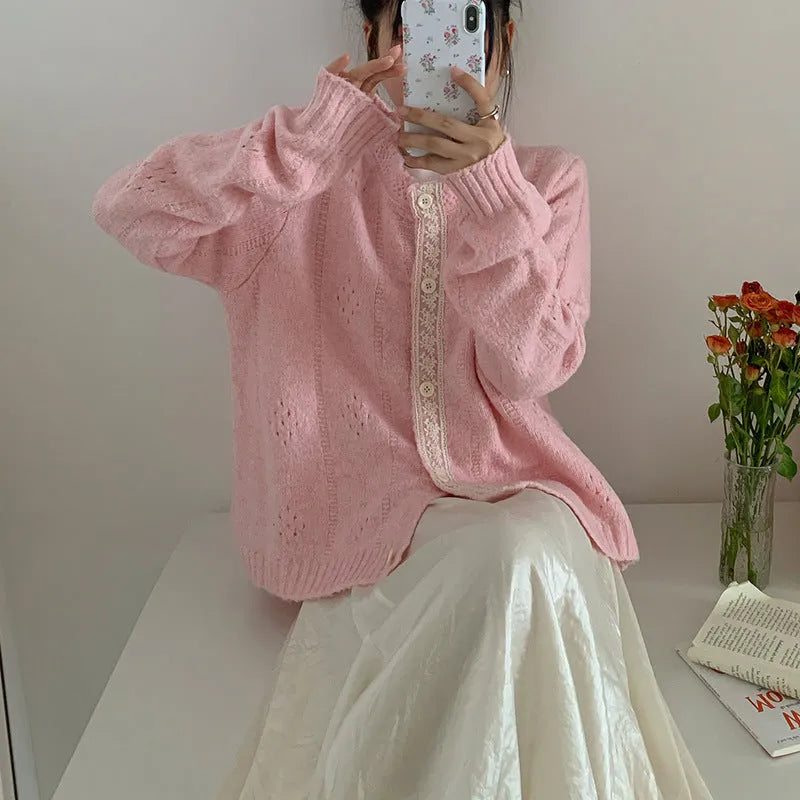 Loose apricot-coloured retro-style knit cardigan coat on a hanger