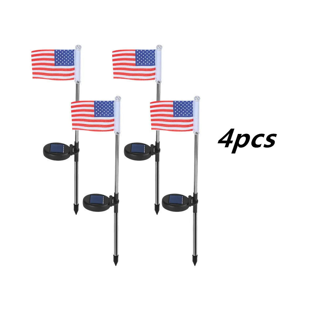 Solar garden flag light with stainless steel pole showing American flag design illuminated at night