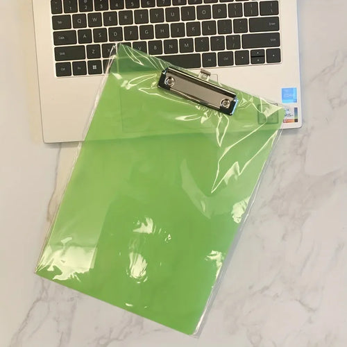 A4 transparent plastic writing board pad with metal clip in blue colour on a desk