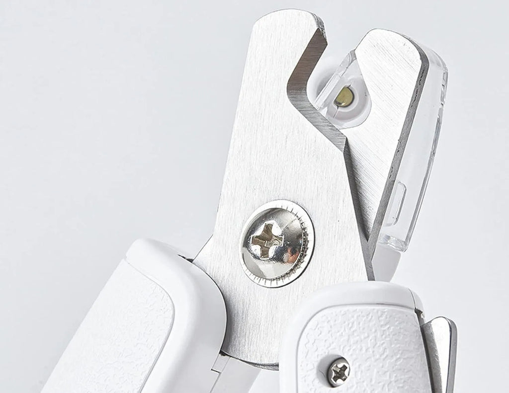 White pet nail clippers with LED light, transparent anti-splash guard and triangular blade for dogs and cats
