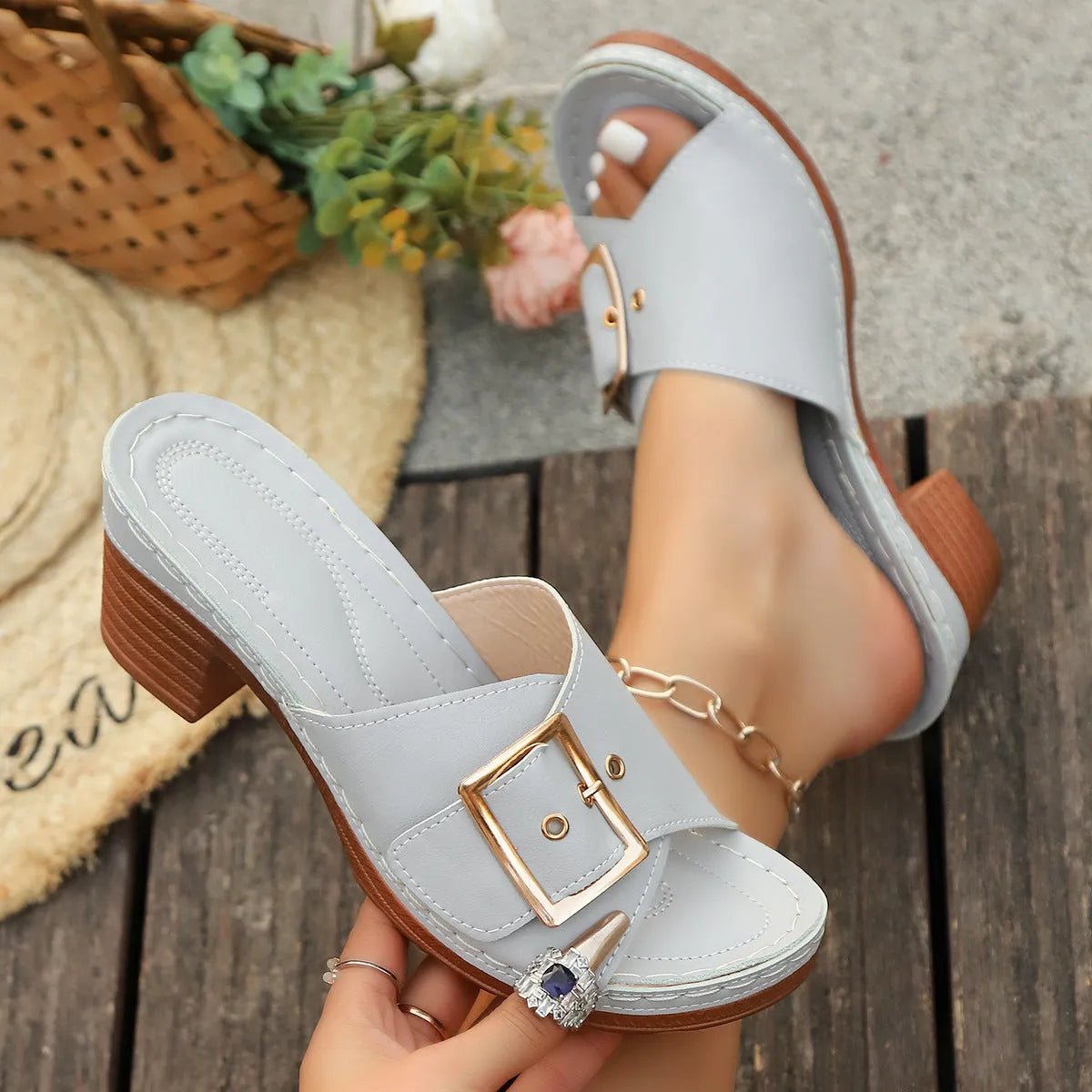 Women's black chunky heel slippers with metal buckle detail and round toe
